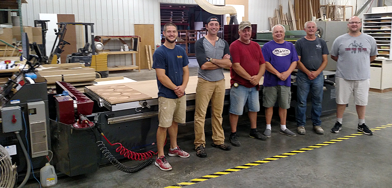 Matt Schiller of AUM Wood Products with his employees and their new Thermwood Cut Center